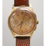 A Swiss 18k yellow metal chronograph manual wind wrist watch, on associated leather strap, with a
