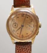 A Swiss 18k yellow metal chronograph manual wind wrist watch, on associated leather strap, with a