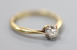 An 18ct and solitaire diamond ring, size Q, gross 2.5 grams, the stone weighing approximately 0.