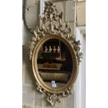 An oval giltwood wall mirror, width 59cm, height 103cm