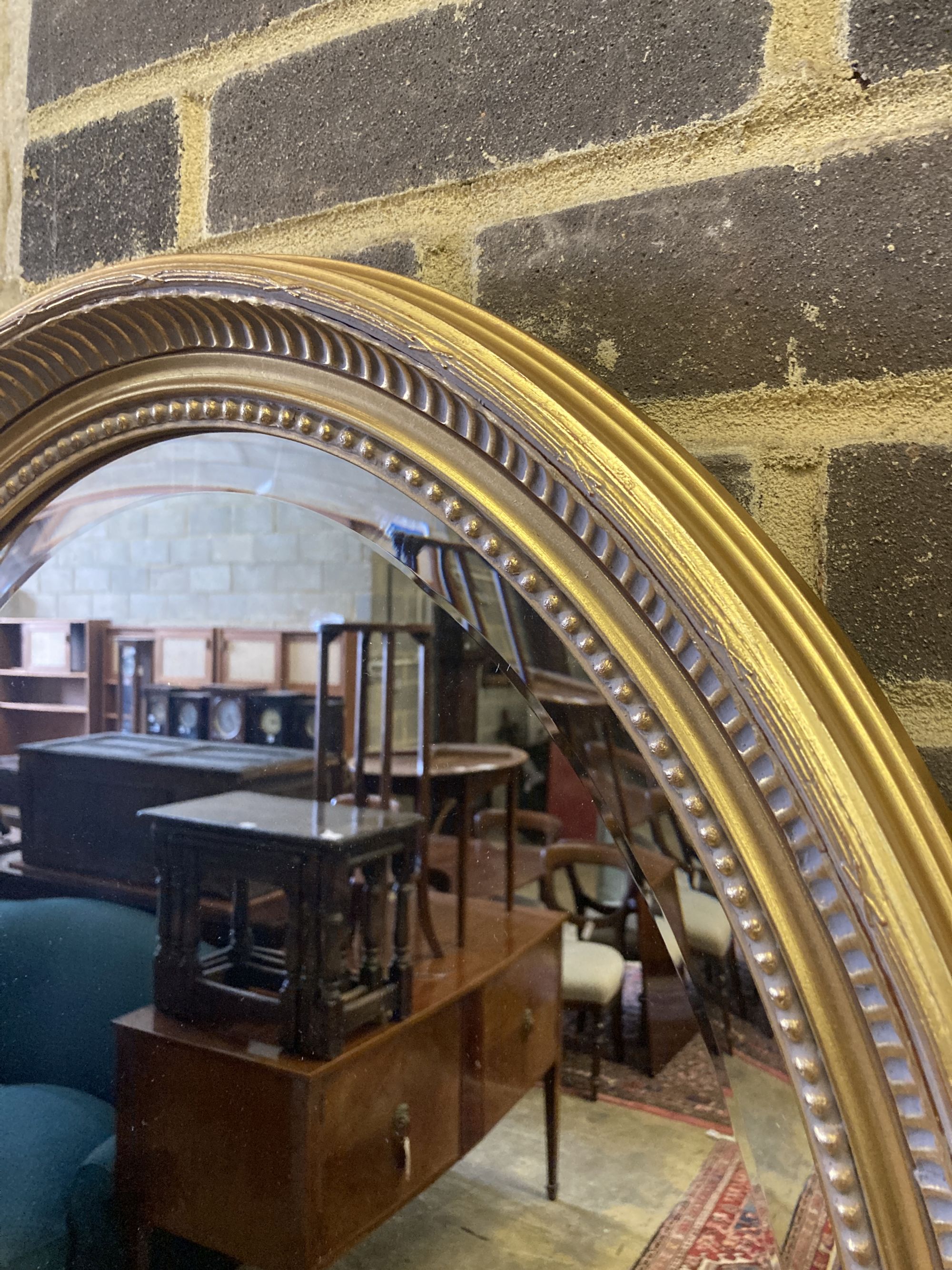 An oval gilt framed bevelled wall mirror, width 58cm height 78cm - Image 2 of 3