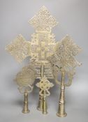 Four Ethiopian Coptic silvered brass processional crosses, the largest with turned wood display