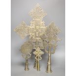 Four Ethiopian Coptic silvered brass processional crosses, the largest with turned wood display