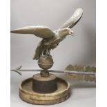 A 19th century American copper weather vane, modelled as an eagle, on an associated wooden base,