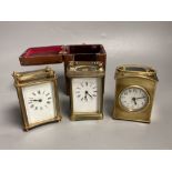 Three small gilt brass carriage timepieces, one with leather outer case, largest 10.5cm high