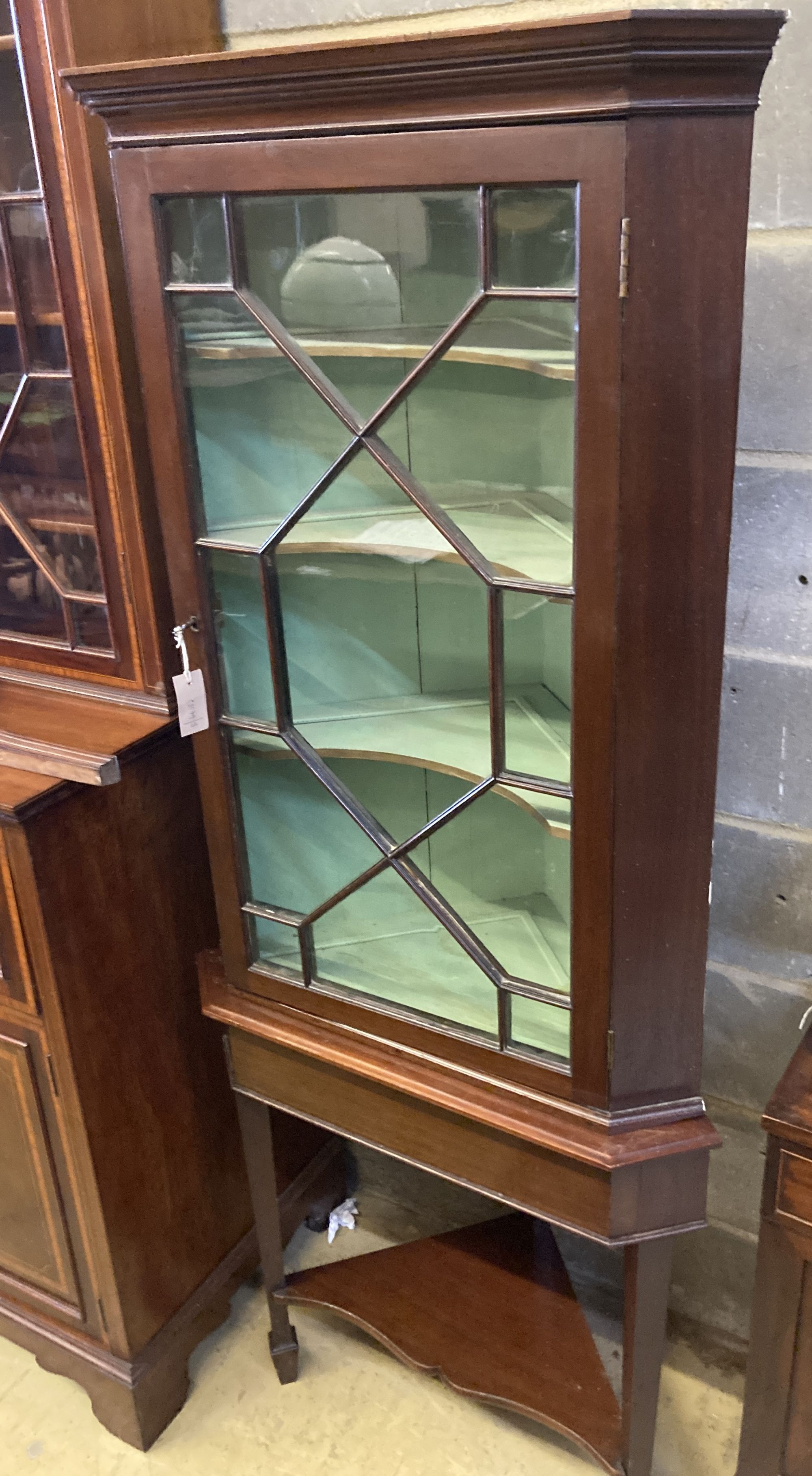 A George III mahogany corner cabinet, on later stand, width 72cm depth 42cm height 177cm