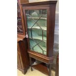 A George III mahogany corner cabinet, on later stand, width 72cm depth 42cm height 177cm