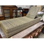 An all weather rattan garden sunlounger with adjustable back, length 210cm, depth 64cm, height 33cm