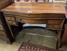 A reproduction mahogany serpentine front writing table, width 106cm depth 57cm height 84cm