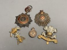 A Turkish Ottoman Order Medjidie Knights Star, another star and three English regimental badges