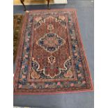 A red ground Shiraz rug, 204 x 132cm