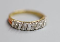 A modern 18ct gold, fives stone baguette and ten stone round cut diamond cluster set half hoop ring,