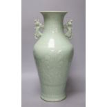 A Chinese green celadon glazed vase, with dragon handles, height 44cm (one re-glued handle)