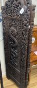 An early 20th century Burmese carved hardwood three fold dressing screen, each panel width 58cm,