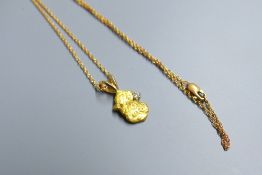 A diamond set 'gold' nugget pendant, 12mm, gross 2.1grams, on a 585 fine link chain, 1.4 grams.