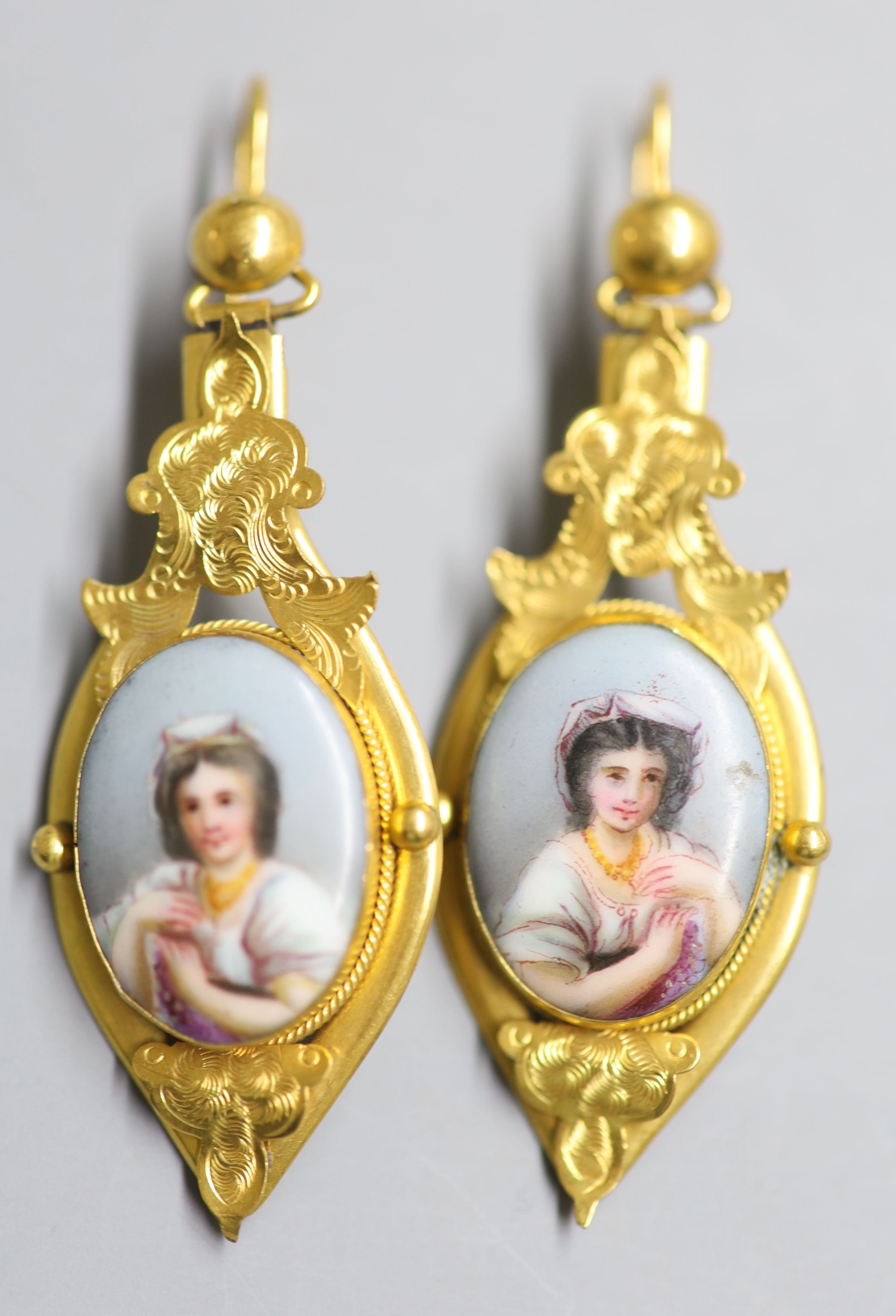 A pair of Victorian style? yellow metal and inset porcelain plaque drop earrings, 52mm, gross 8.4