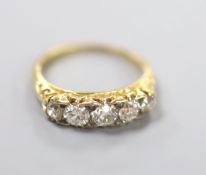 An early 20th century yellow metal and graduated five stone diamond set half hoop ring, size N,