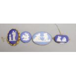 Four assorted late 19th/early 20th century yellow metal mounted Wedgwood plaque brooches,