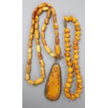 Two Chinese single strand amber necklaces including one with pendant, 34cm, gross 24 grams and