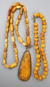 Two Chinese single strand amber necklaces including one with pendant, 34cm, gross 24 grams and