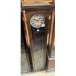 An early 20th century oak cased electric pendulum clock