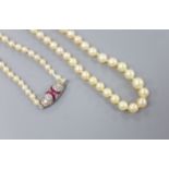 An early 20th century single strand graduated seed pearl necklace, with white metal ruby and diamond