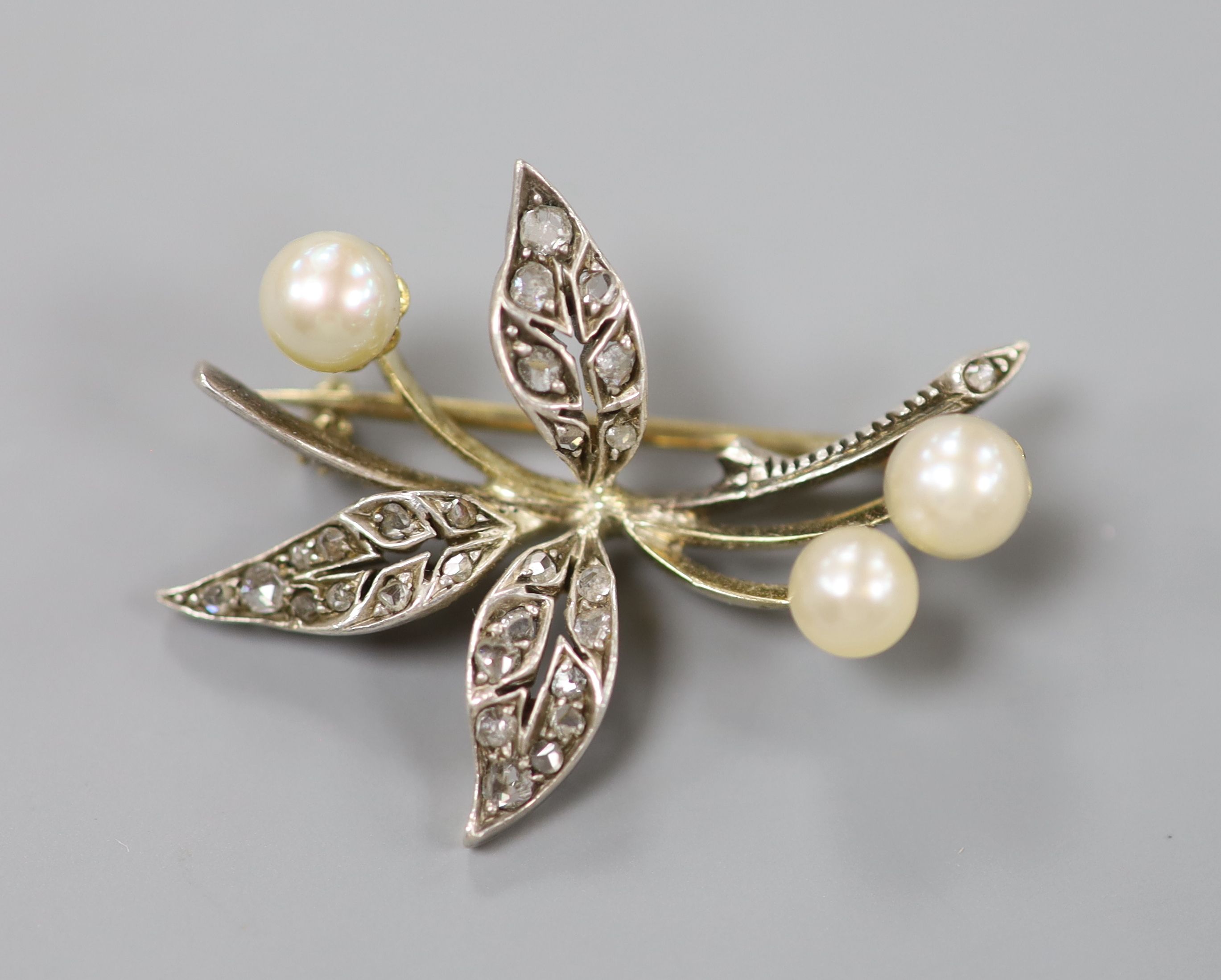 An early 20th century yellow and white metal, cultured pearl and rose cut diamond set floral spray