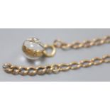 A 9ct gold oval link chain, 35.5cm, 14.5 grams and a yellow metal mounted bullseye pendant locket.