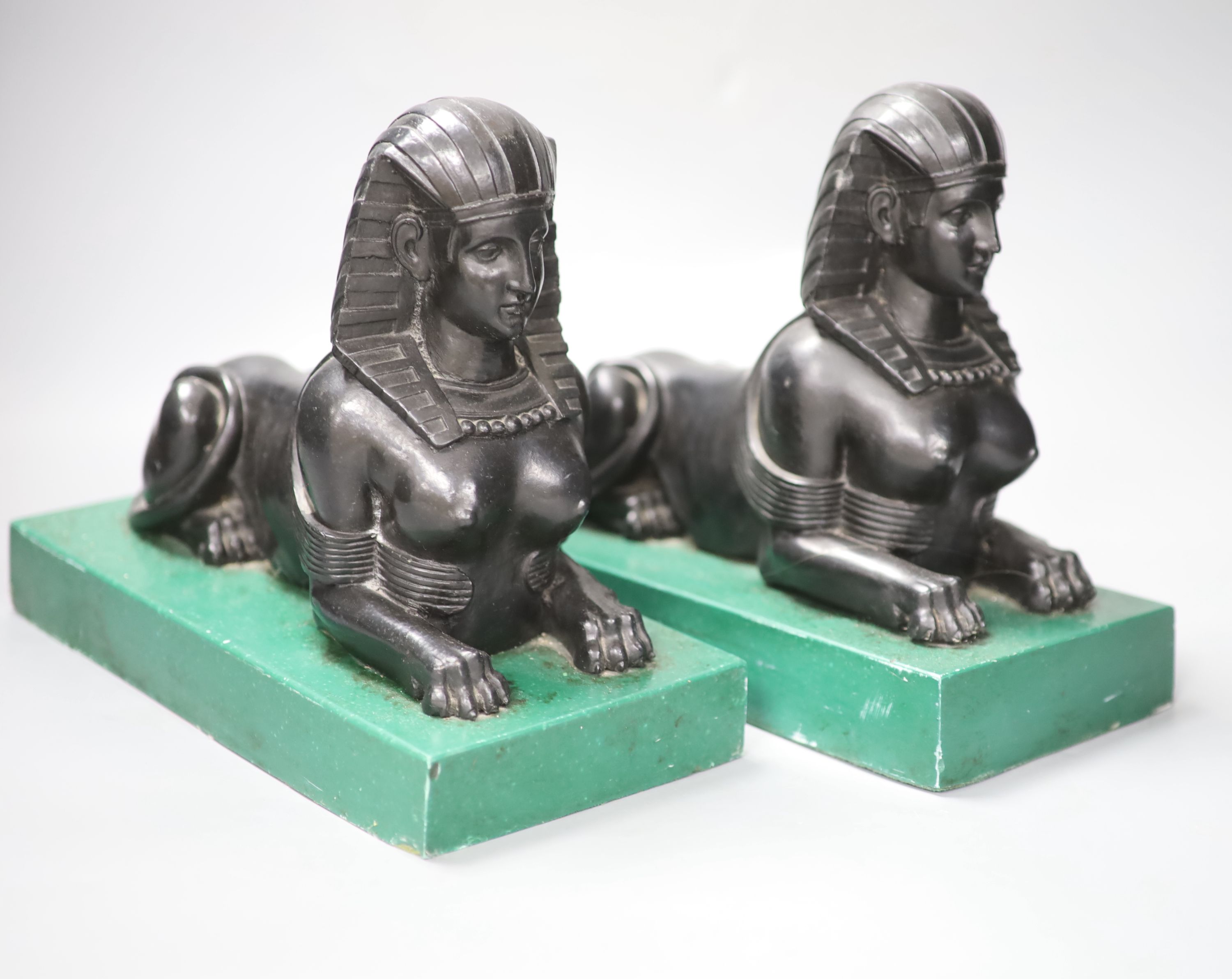 A pair of Egyptianesque composition bookends, each modelled as a Sphinx, width 28cm height 23cm