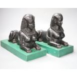 A pair of Egyptianesque composition bookends, each modelled as a Sphinx, width 28cm height 23cm