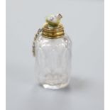 A 19th century yellow metal mounted cut glass scent bottle, with porcelain chick mounted stopper,