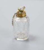 A 19th century yellow metal mounted cut glass scent bottle, with porcelain chick mounted stopper,