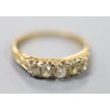 An early 20th century yellow metal and graduated five stone diamond set ring, size O, gross 2.6
