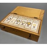 A collection of 48 histology slides contained in a fitted lightwood case, mainly botanical