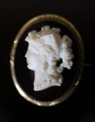 A Victorian gilt metal mounted composition glass? oval cameo brooch, carved with bust of a lady to
