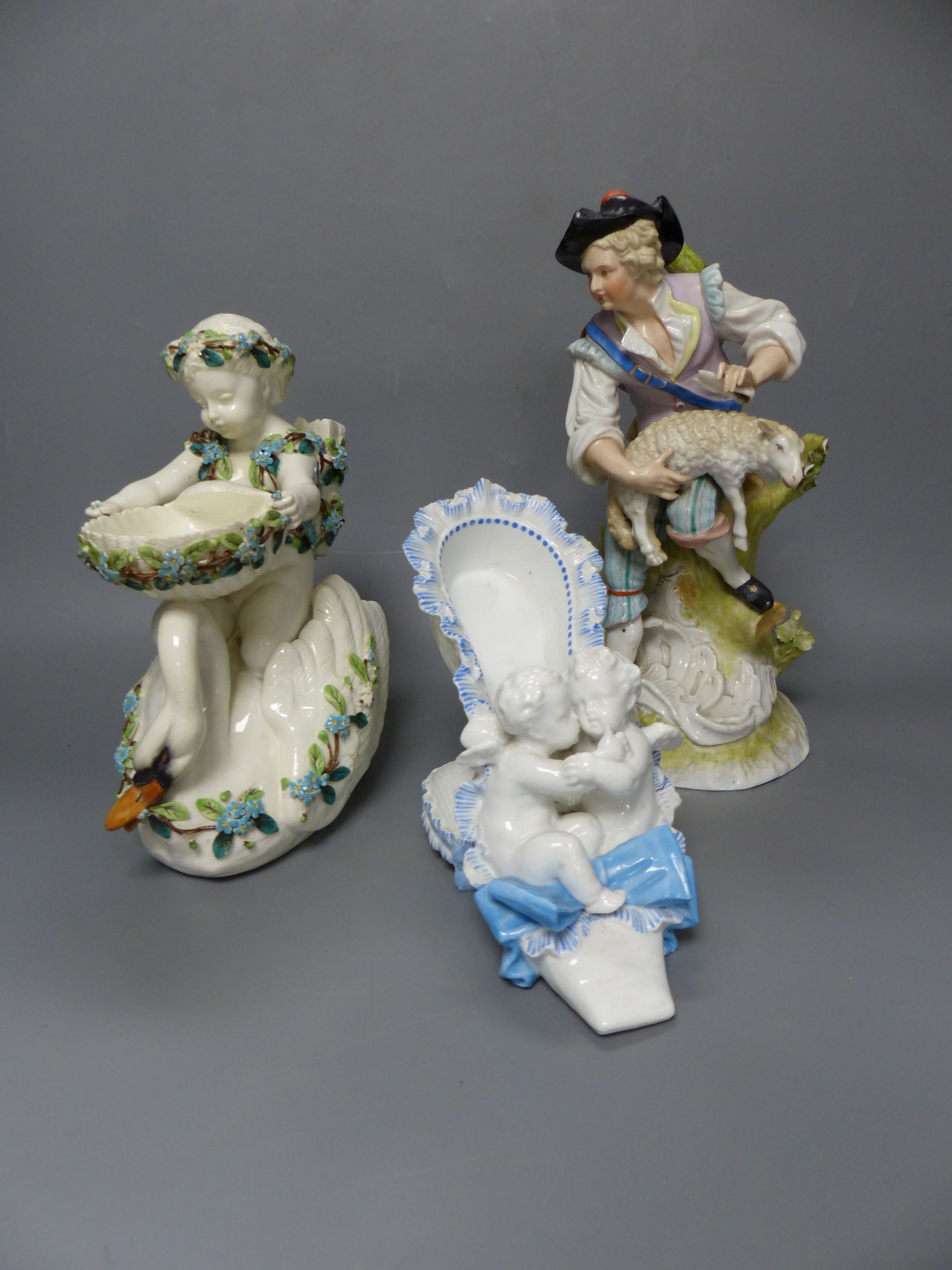 A French porcelain cherub 'shoe', a Continental porcelain cherub and swan dish and group of a