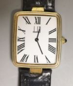 A gentleman's silver gilt Dunhill quartz shaped rectangular dial wrist watch, on a leather strap