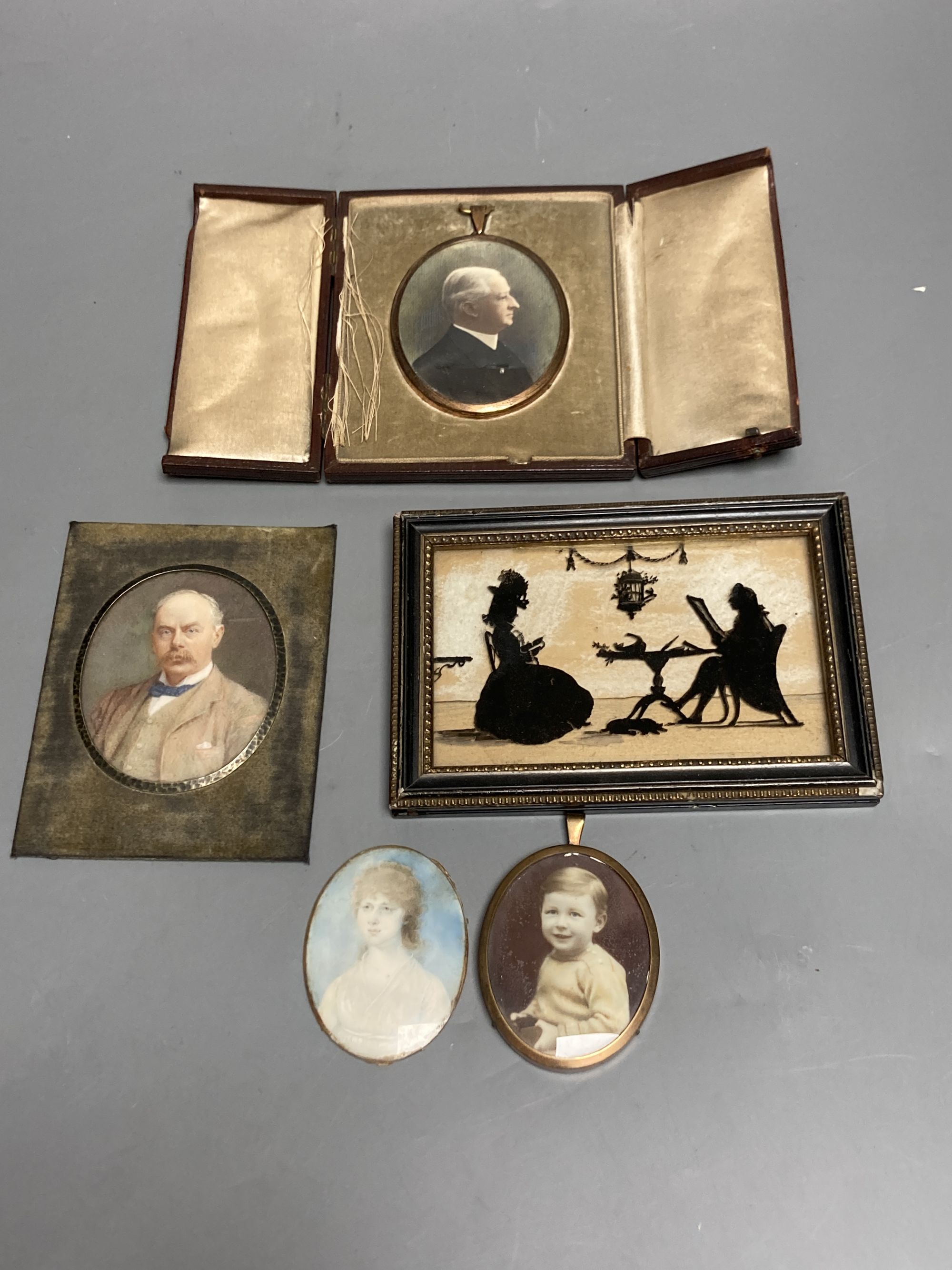 A collection of miniature portraits, including an early 19th century portrait of a young woman,