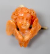 A 19th century yellow metal mounted coral brooch, carved as the bust of a cherub, 22mm, gross 5.3