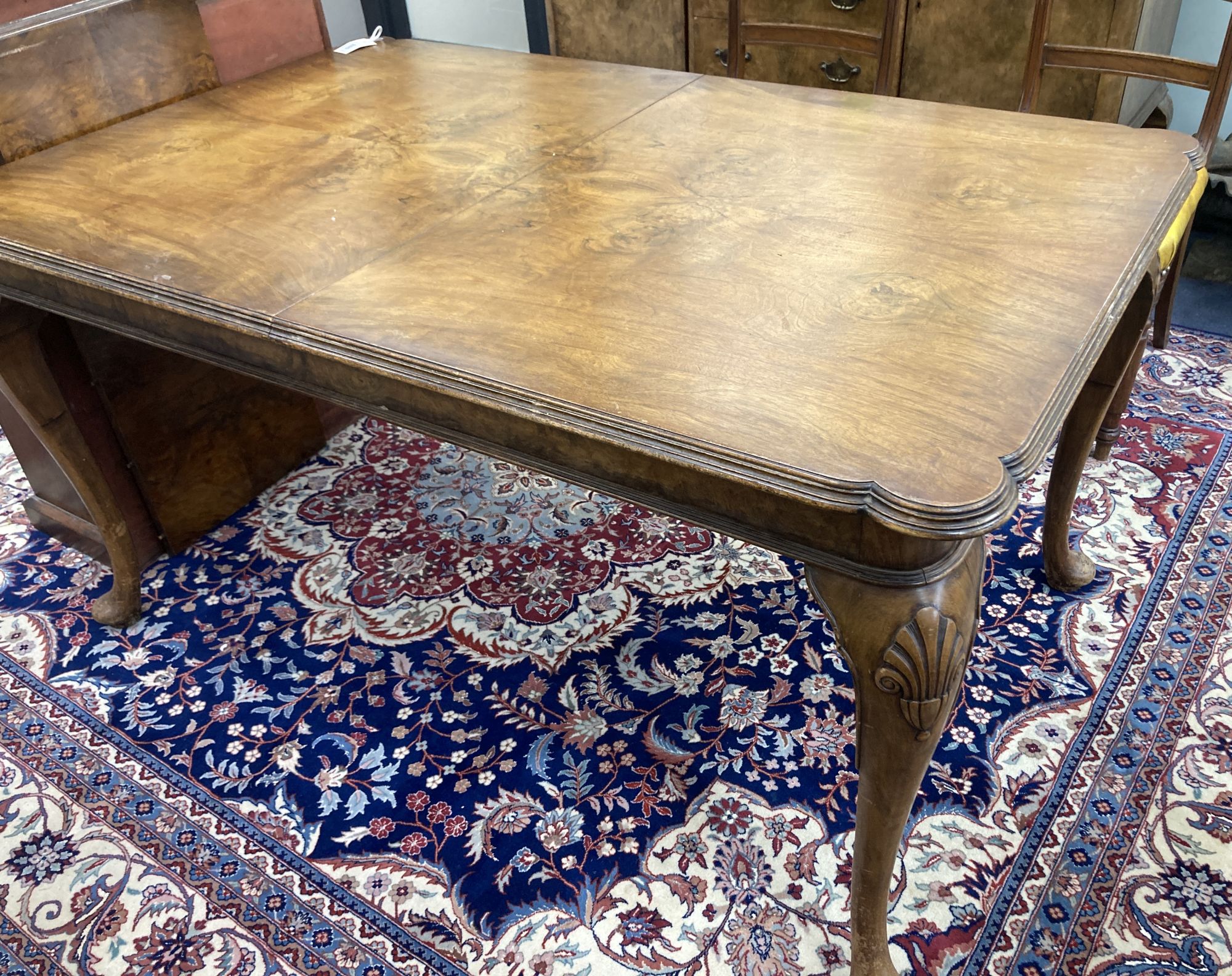 A Queen Anne revival walnut extending dining table, length 182cm extended (one spare leaf), width