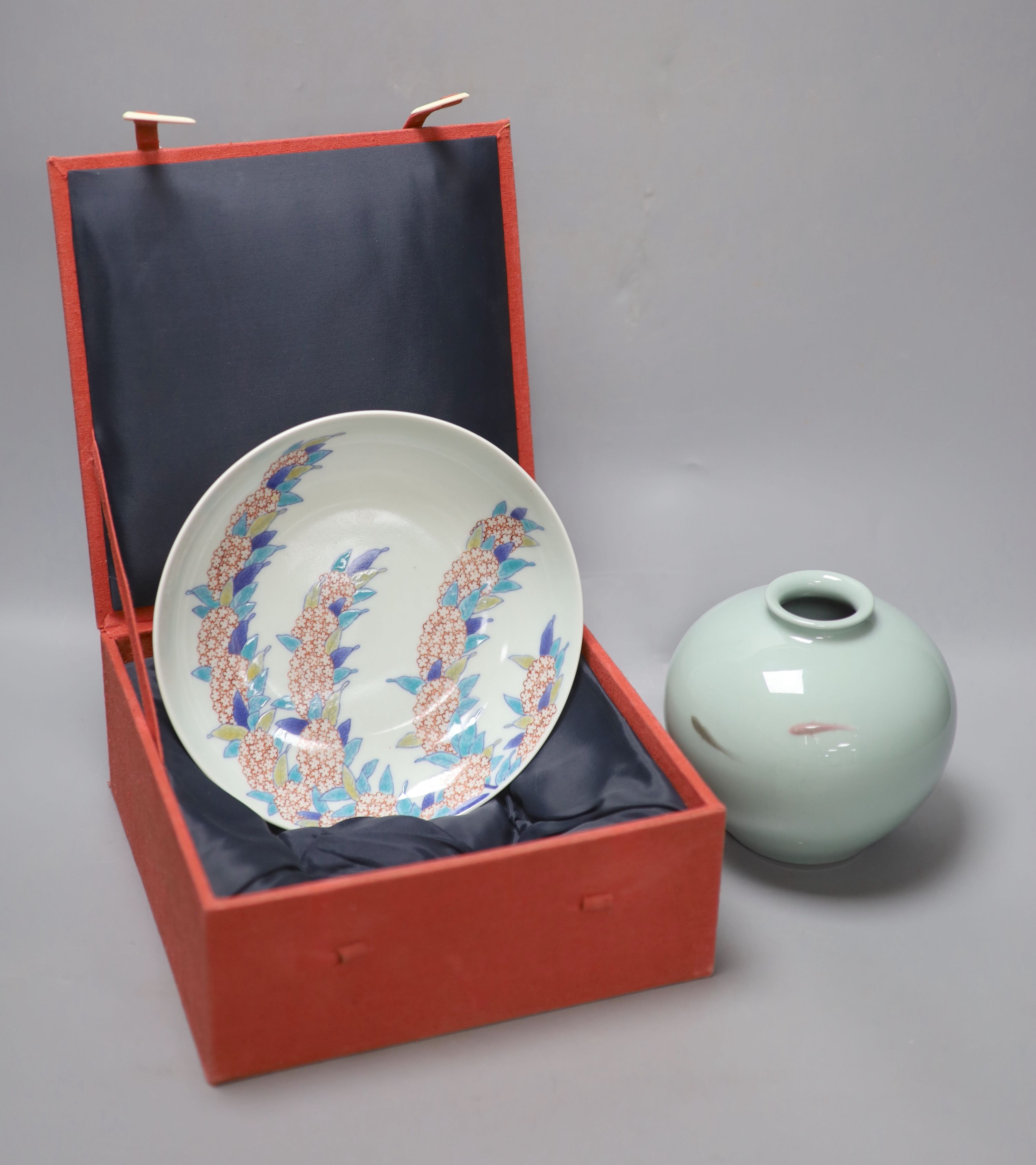 A Japanese celadon jar with fish and a Nabeshima style dish, both 1900, diameter 20cm