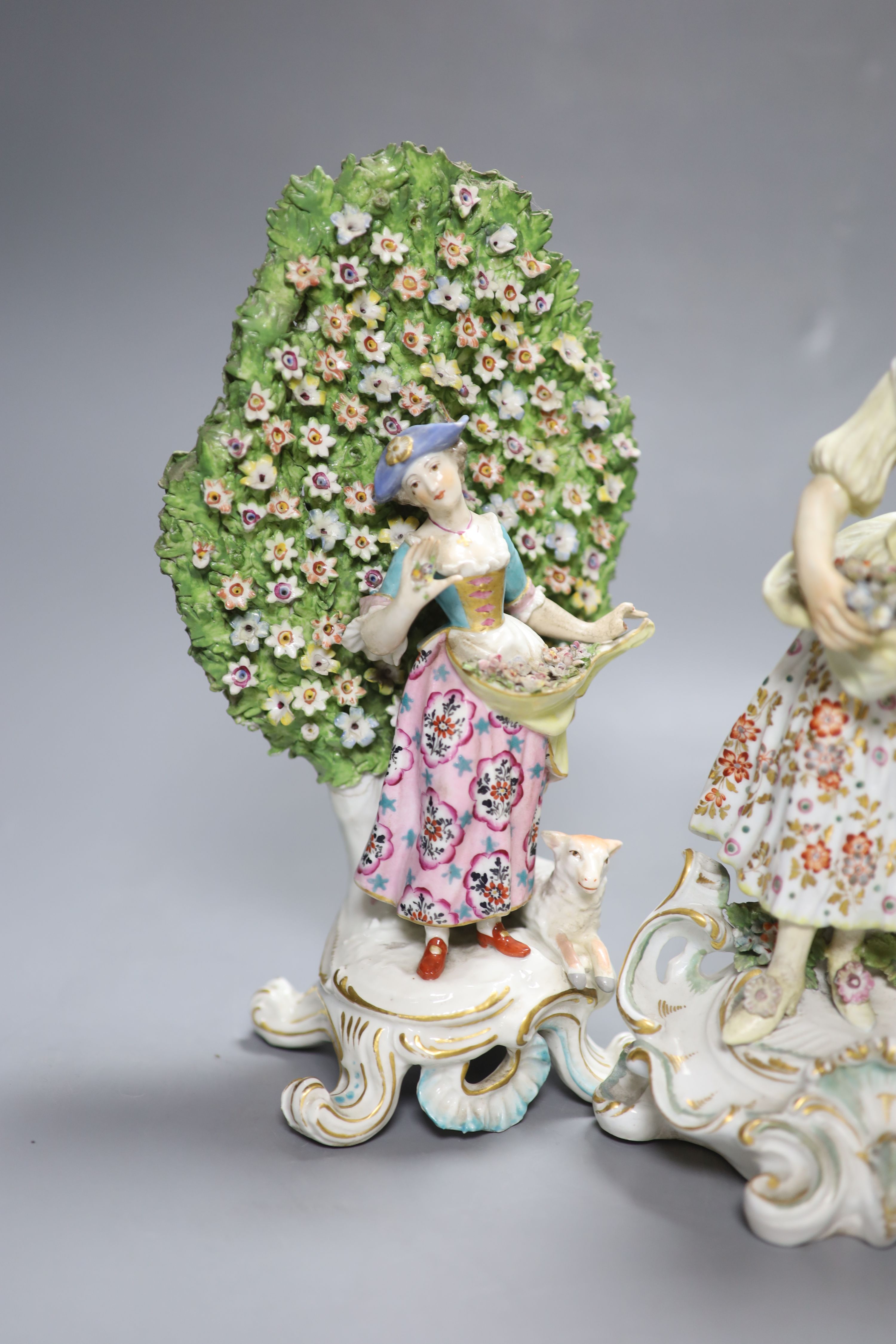 An 18th century Derby figure of a flower seller and a pair of French porcelain bocage groups, - Image 2 of 4