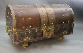 An ormolu and brass mounted leather dome top coffer, with bold studded decoration over a brown