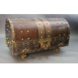 An ormolu and brass mounted leather dome top coffer, with bold studded decoration over a brown