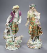 A pair of 18th century English Chelsea Derby figures of a boy and girl holding animals, height 25cm