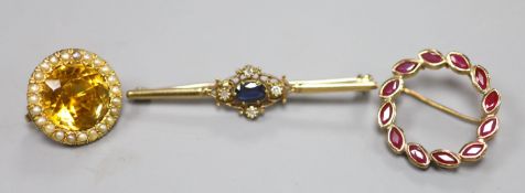 A 9ct gold sapphire and diamond bar brooch, 48mm, gross 2.9 grams, a 375 and ruby wreath brooch,