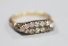 A yellow metal and two row twelve stone diamond set dress ring, size P, gross 2.6 grams.