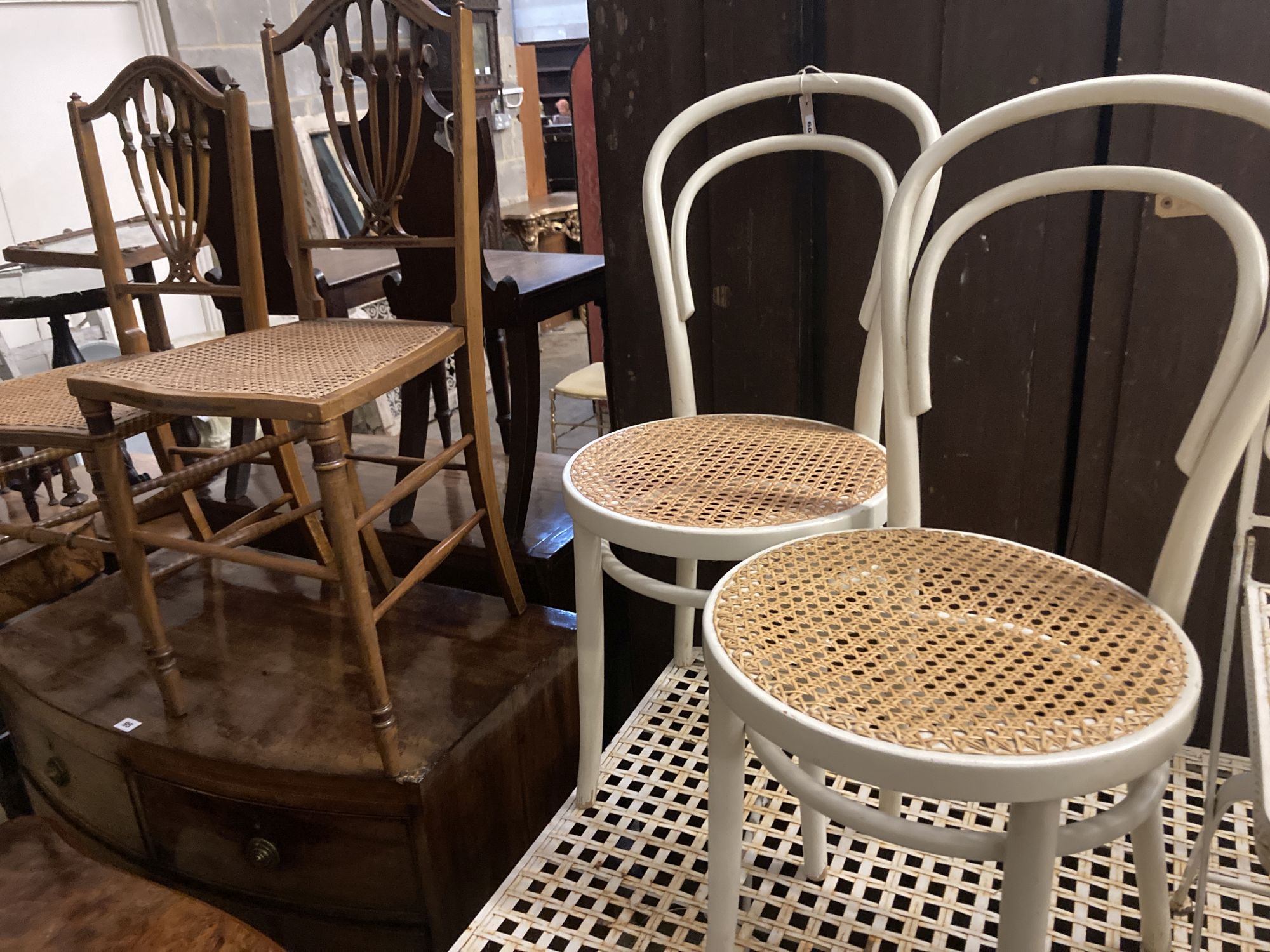 Two Edwardian cane seat chairs and a pair of painted Bentwood cane seat chairs