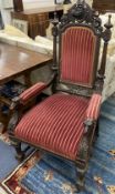 A late 19th century oak Carolean style armchair, with carved dog's head arms, width 68cm, depth