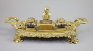 A Victorian ormolu ink stand, the central wafer box applied with a bust of a Shakespeare and flanked